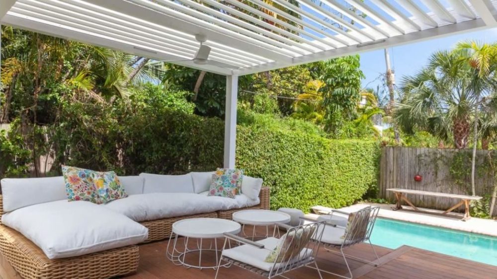 Angled pergola slats - motorized louvered roof in white