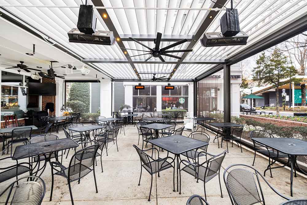 heaters, fan and open motorized louvered roof - Commercial outdoor space with R-BLADE pergola by Azenco