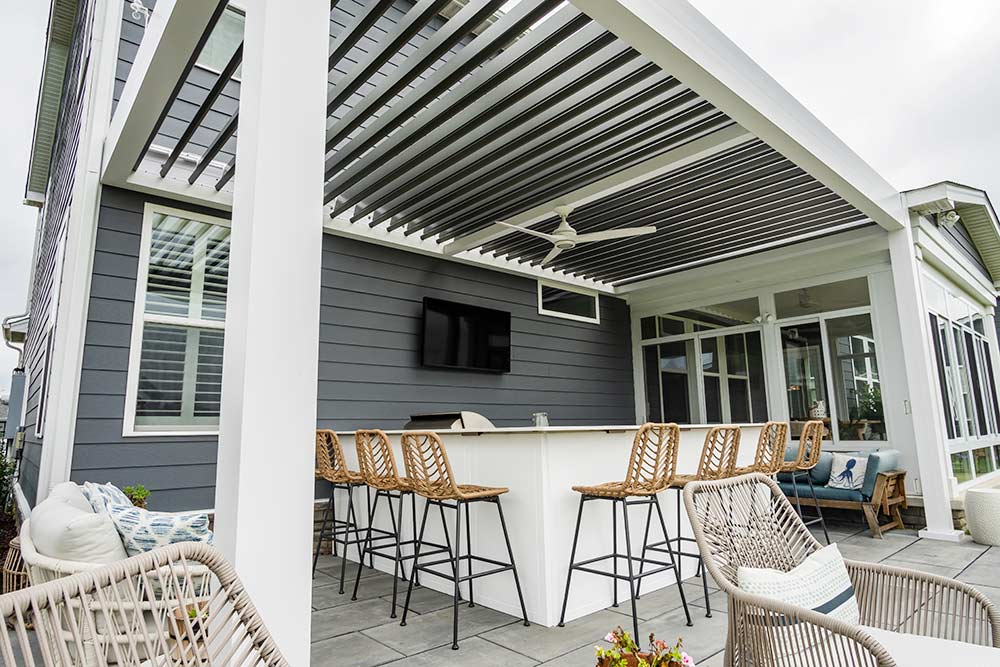 Dual-toned motorized louvered pergoal in Virginia Beach is the focal point of this coastal home - Azenco
