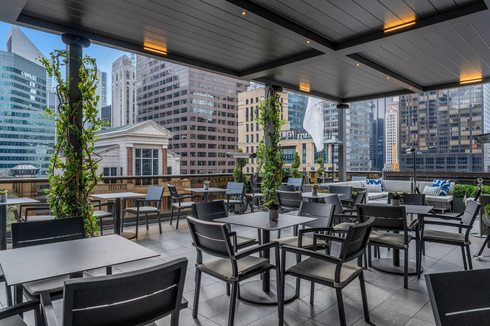 commercial gray bronze automated pergola featuring premium additions like led lights and speakers