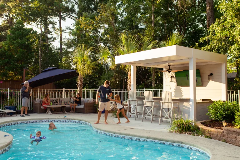 white r-shade in a backyard with a pool